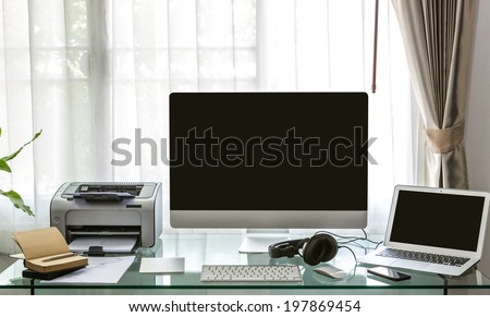 Modern home office with computer and laptop