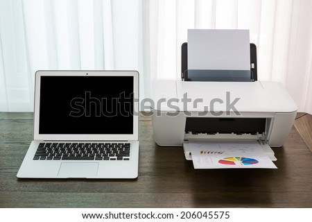 printer and Laptop on wood table