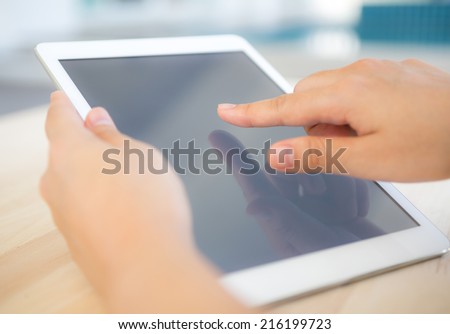 Woman hand hold  white tablet with blank empty screen