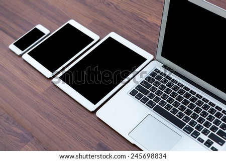 laptop with tablet and smart phone on table