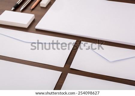 Blank Template. Consist of Business cards, letterhead a4, pen, envelopes,pencil,eraser on wood table
