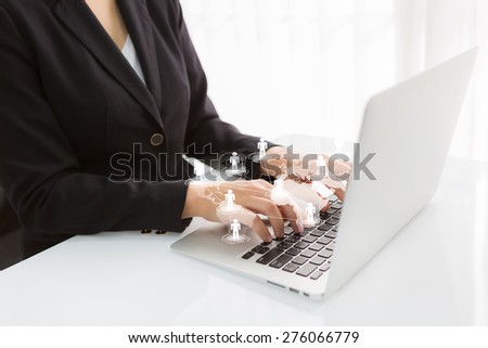 Social networking concept : Business woman hand typing on Laptop with social network on world map