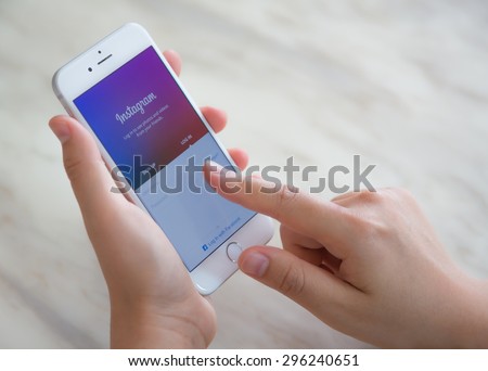 Loei, Thailand - July 12, 2015: Hand holding Iphone with mobile application for Instagram on the screen