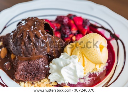 Chocolate cake with fruit peach, black currant, blueberry, apple, ice cream