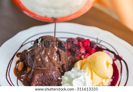 Chocolate cake with fruit peach, black currant, blueberry, apple, ice cream