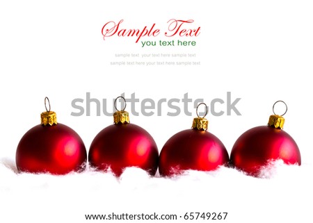 shiny red christmas balls in billowy feathers with copy space.