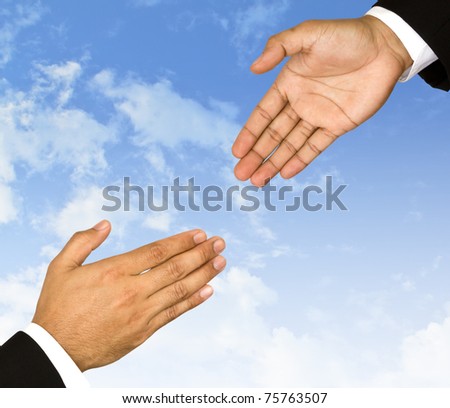Businessman  hand is reaching out in the sky for help