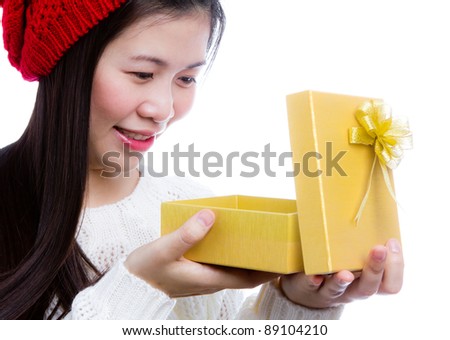 Beautiful woman with golden boxed gift in her hands on white background