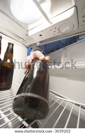 Man reaching into the fridge for a cool beer