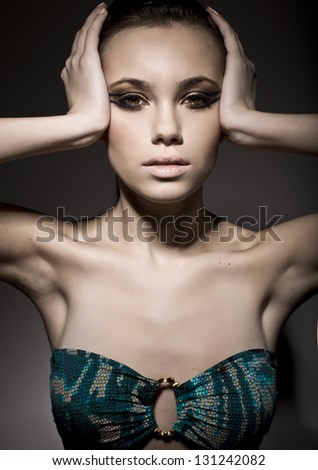 Seductive girl super model  posing in studio over black background with bra