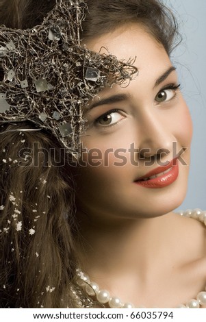beautiful model with long hair and  star and pearls posing fashion in studio smiling