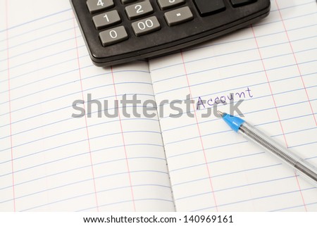 Papers on financial figures with calculator and pen.