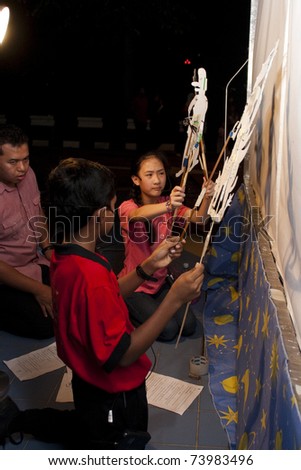 KUALA LUMPUR, MALAYSIA-MAR 26:Volunteer of Earth Hour Campaign perform a shadow puppet show on Mar 26, 2011 in Kuala Lumpur.More than 4,000 cities in 131 countries celebrate Earth Hour.