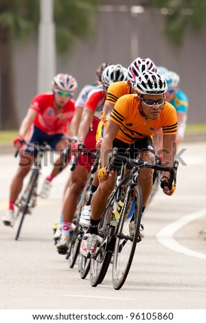 PUTRAJAYA, MALAYSIA - FEB 18: Unidentified cyclists from Malaysia team during in Elite Men\'s Road Race (179.2km) at the 32nd Asian & 19th Junior Asian Cycling Championships on Feb 18, 2012 in Putrajaya, Malaysia.
