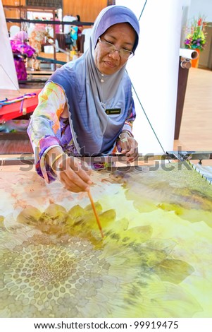 KUALA LUMPUR-MARCH 26: Mrs. Shakirah, a traditional batik painter does a demonstration at the Malaysia National Craft Day 2012 on March 26, 2012 in Kuala Lumpur, Malaysia.