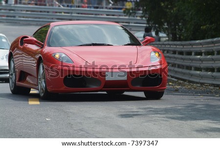 Red, Italian sports car at a race track