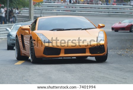 Orange, Italian sports-car on a racetrack