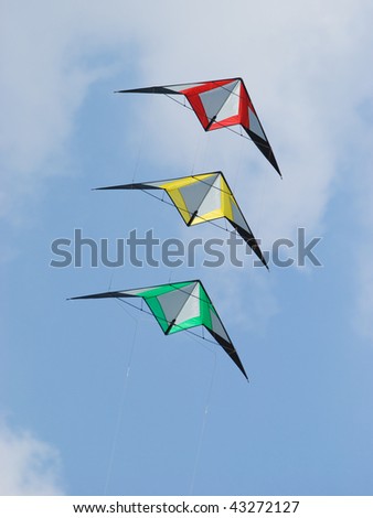 Stack of three stunt kites in the colours red, yellow and green.