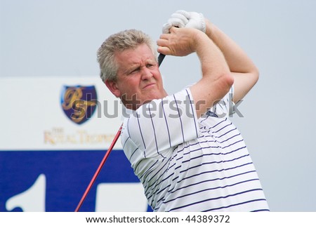 BANGKOK, THAILAND - JANUARY 9: Scottish golf player and team captain Colin Montgomerie tees off at the Royal Trophy tournament, Asia vs Europe at Amata Spring January 8, 2010 in Bangkok, Thailand.