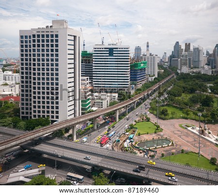 Bangkok view with Rama IV road in the foreground and Rachadamri road with Silom Sky-train line disappearing into the background. Two buildings on the left are the Red Cross Chulalongkorn Hospital.