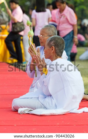 BANGKOK, THAILAND - DECEMBER 5: Female monks praying at a shrine during the celebration of the 84th birthday of H.M. King Bhumipol Adulyadej in Bangkok, Thailand on December 5 2011.