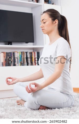 Yoga Meditation Woman Relaxing at home.Healthy Lifestyle in Lotus Posture .Caucasian female meditate on the floor.