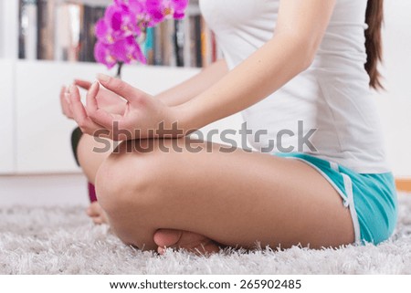 Yoga Meditation Woman Relaxing at home.Healthy Lifestyle in Lotus Posture .Unrecognizable caucasian female meditate  on the floor.