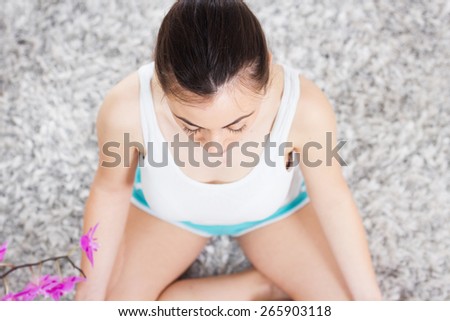Yoga Meditation Woman Relaxing at home.Healthy Lifestyle in Lotus Posture .Caucasian female meditate on the floor.View from above.