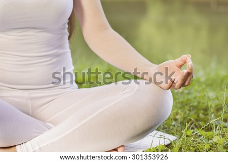 Yoga Meditating Zen Woman Relaxing Outdoor.Healthy Lifestyle in Lotus Posture .Unrecognizable caucasian female meditate.