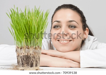 Smiling Girl Watching A Plant Grow. Stock Photo 70939138 : Shutterstock