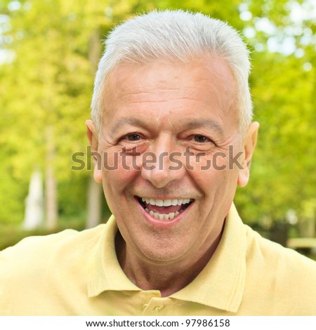 Portrait of smiling senior man outdoors.