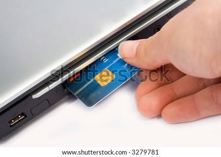 Credit card inserted in laptop - Concept for Internet Banking & Shopping
