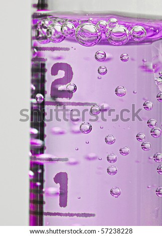 Lab chemistry - bubbles reaction in flasks closeup
