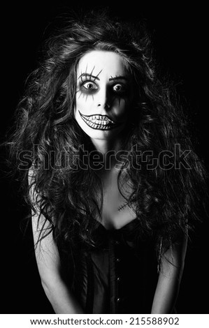 Beautiful young woman in the image of a sad gothic freak clown. Black and white