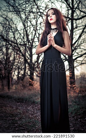 Portrait of beautiful goth girl amongst the trees