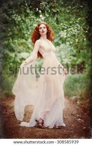 Gorgeous redhead woman wearing white dress in the forest. Grunge texture effect