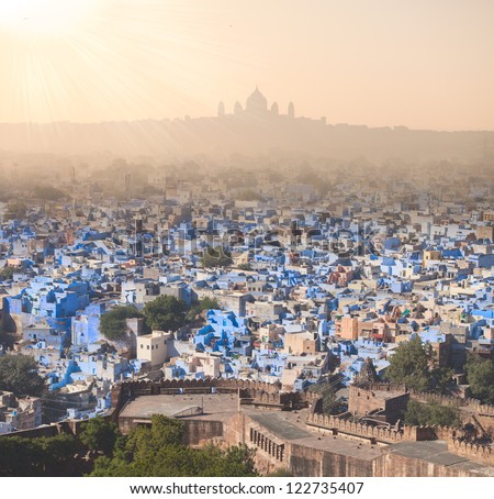 majestic view to blue city Jodhpur with Umaid Bhawan Palace behind, sun rays, India
