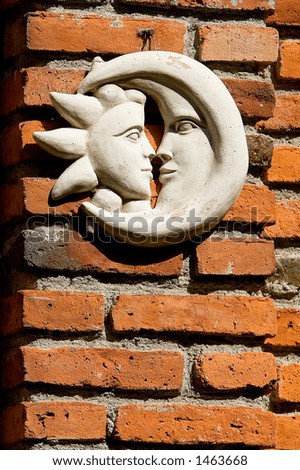 Brick wall with moon and sun.
