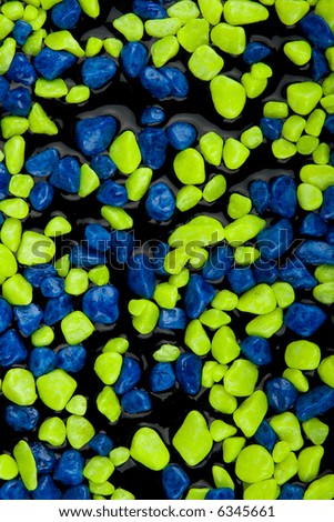 Colorful decorated aquarium gravel background and water