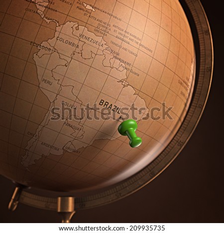 Antique globe with the Brazil marked by the pin. Clipping path included.