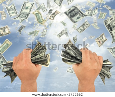 Wealth idea in a metaphor of rain of dollars. The hand holds some dollars.