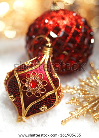 Christmas decoration red and gold ornaments on snow still life