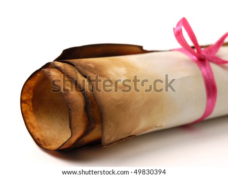 Close-up of a roll of yellowish burnt vintage parchment tied with a red ribbon Isolated over white background