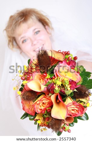beautiful fall wedding bouquet with bride in background.
