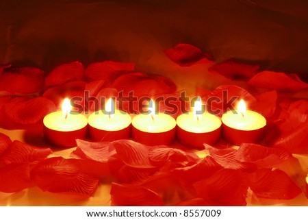 Valentines day candles and rose petals.