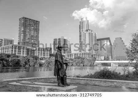 AUSTIN, TEXAS - SEPTEMBER 27: Stevie Ray Vaughan statue in front of downtown Austin and the Colorado River from Auditorium Shores on September 27, 2014 in Austin, Texas