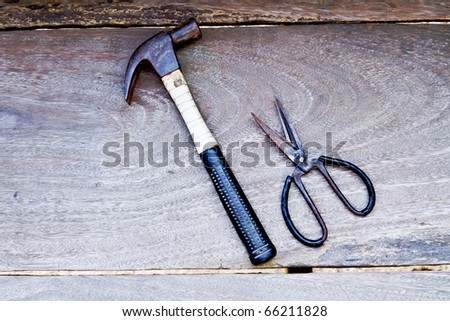 Hammer, scissors, paste on a piece of wood