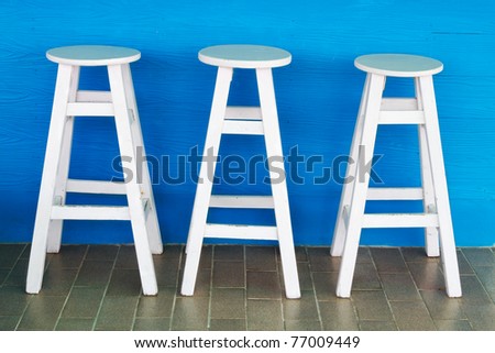 Round, white wooden chairs