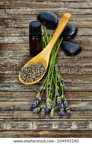 lavender aromatherapy (fresh and dried lavender flowers,  essential oil, zen stones) on a wooden surface
