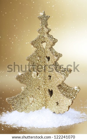 Gold christmas tree on gold background